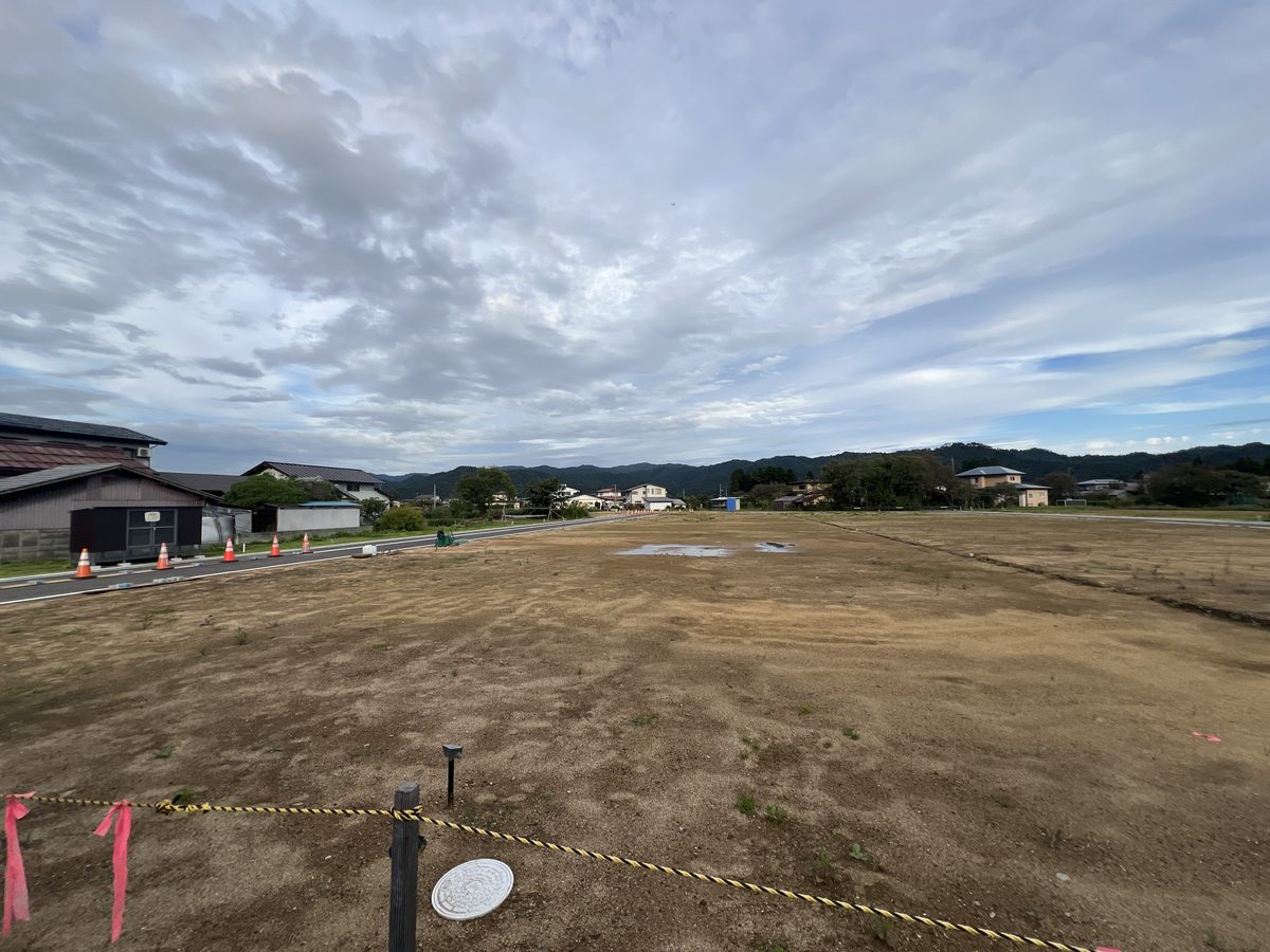 花咲きタウン みずはの郷 narita の現地。造成が終わった平らな土地と、奥に見える山並み